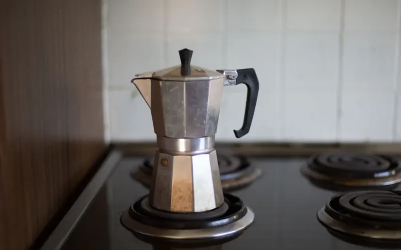Copper cezve on low heat for traditional Turkish coffee brewing